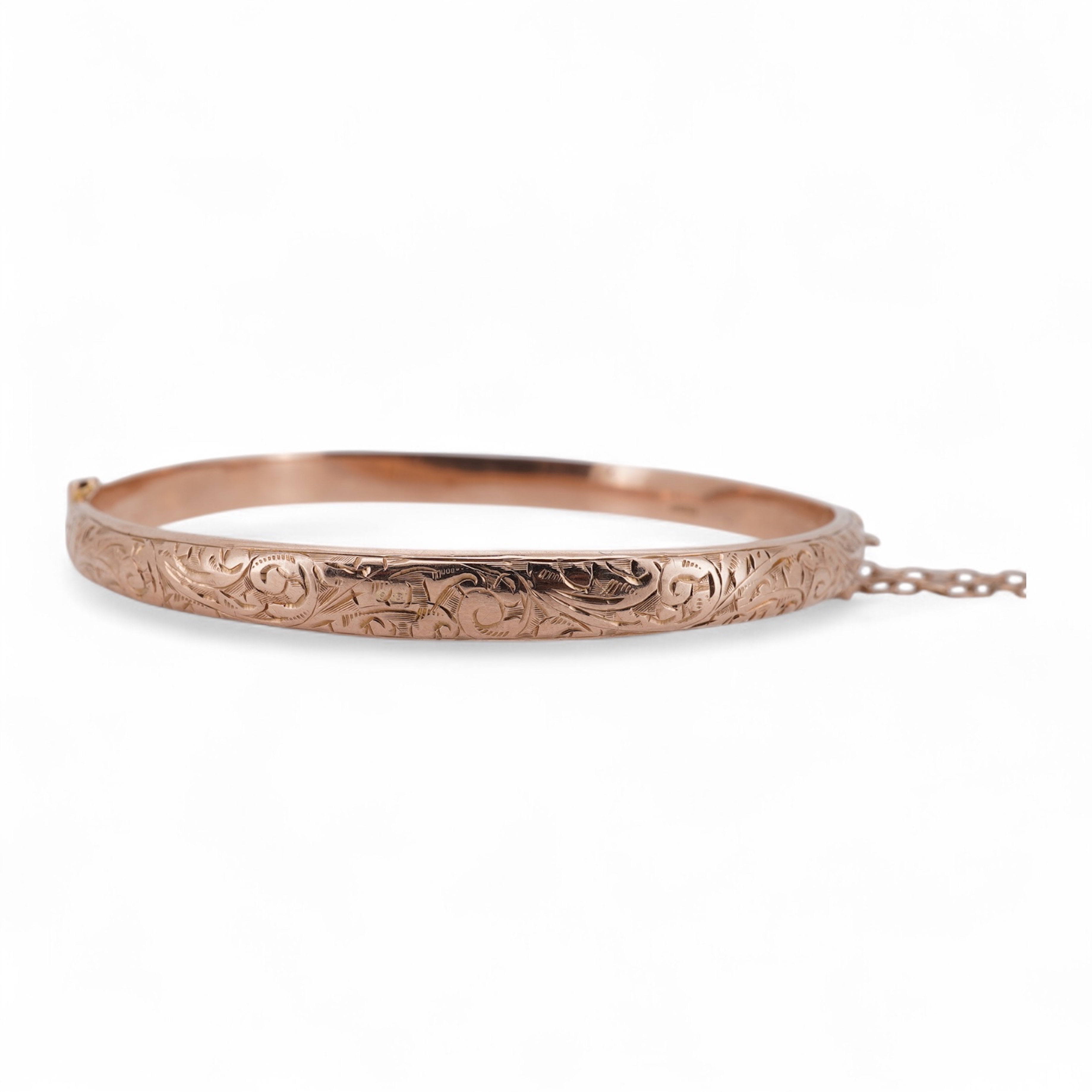 A George V part engraved 9ct gold hollow hinged bangle, Birmingham, 1911, interior diameter 57mm, 5.5 grams. Condition - poor